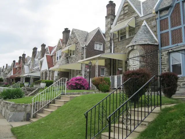 A row of houses with steps leading to them.