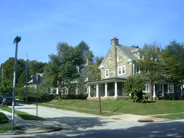 A large house with many trees in the background