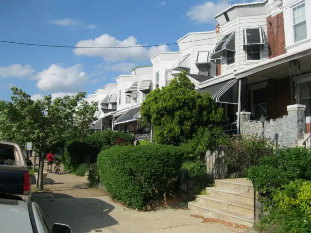 A row of houses on the side of a street.